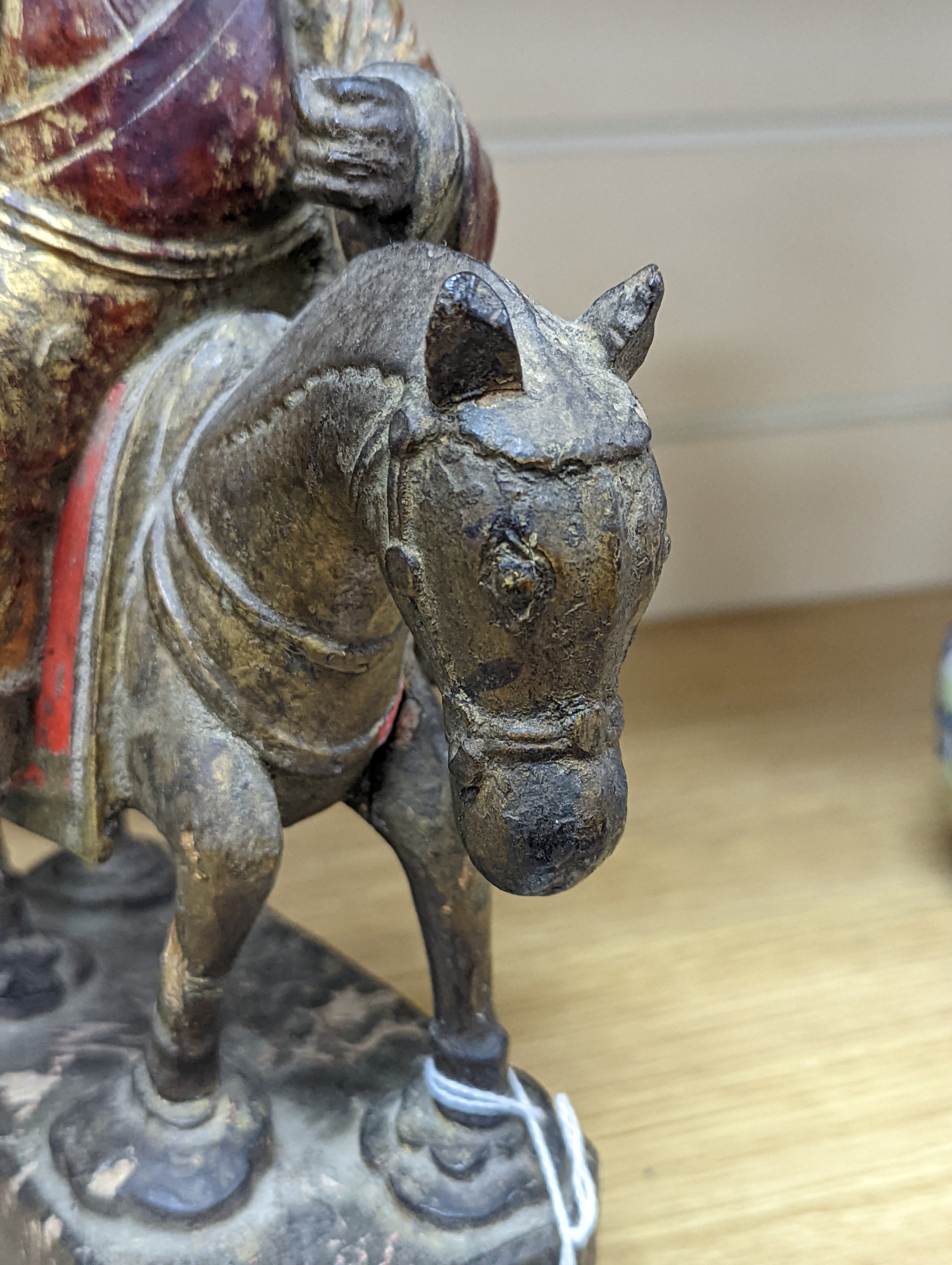 An 18th/19th century Chinese lacquered wood group of an official riding a horse, 30cm